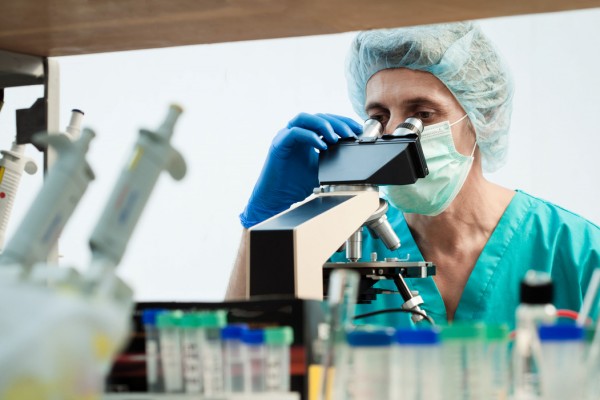 bigstock-scientist-looking-into-a-micro-143927693