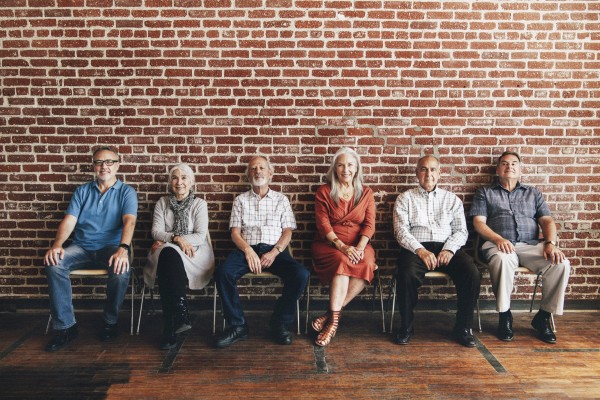 diverse-elderly-people-sitting-in-a-row-against-a--YRCMQZW